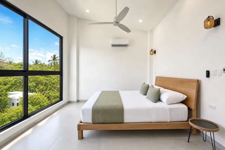 Selva Dorada master bedroom with white linen bed
